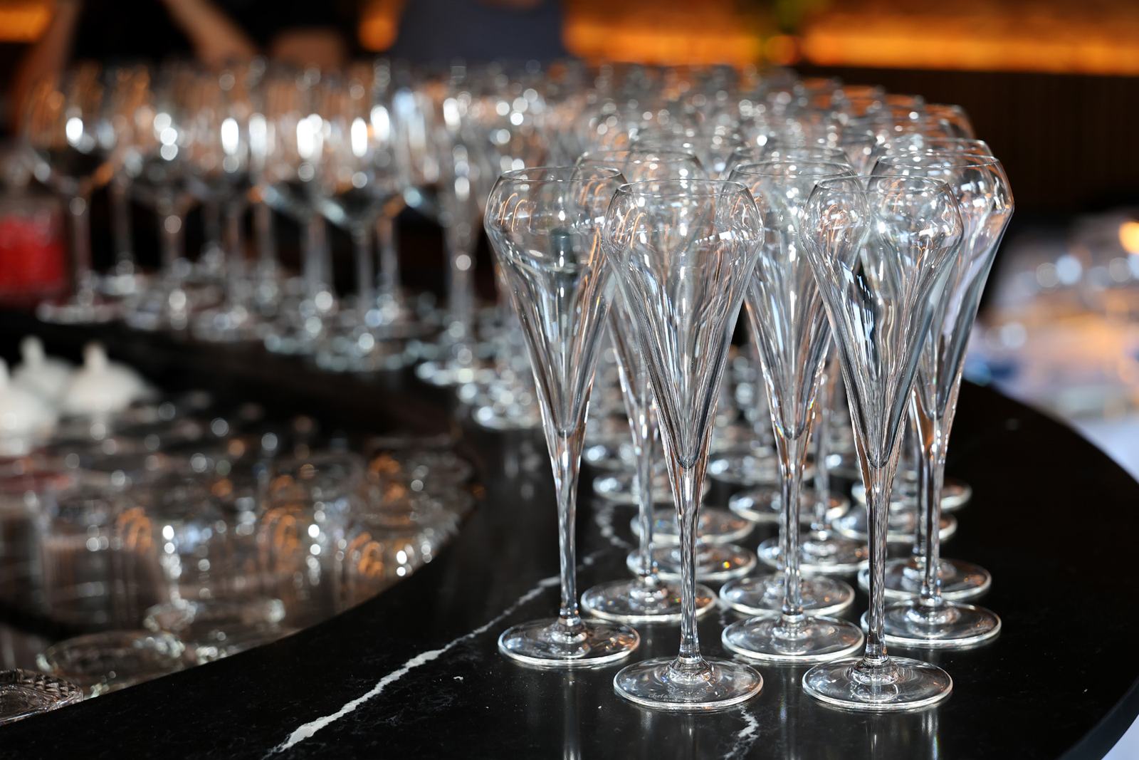 Prosecco glasses lined up on the bar