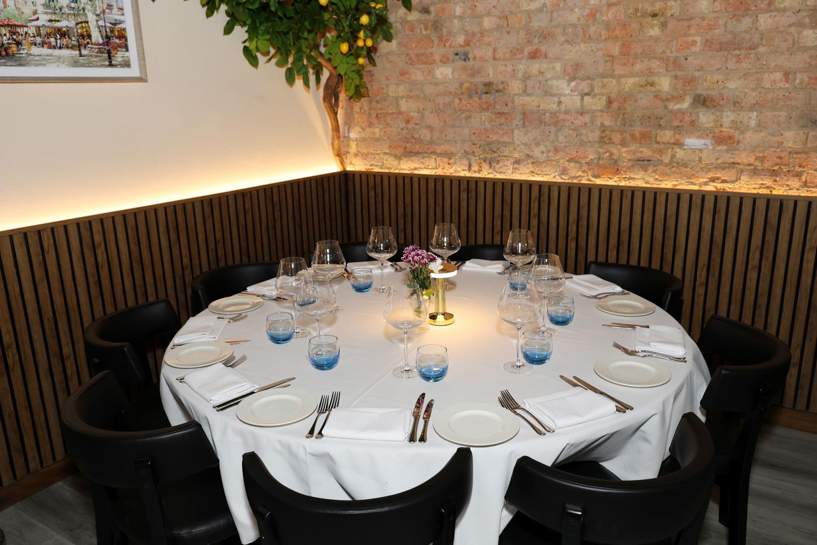 A round table laid for the guests