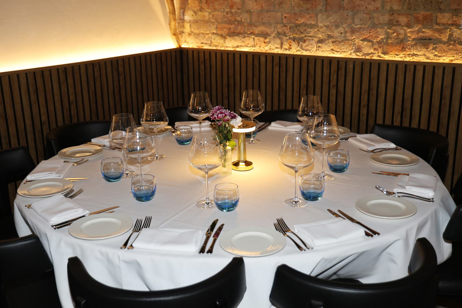 A round table laid for the evening